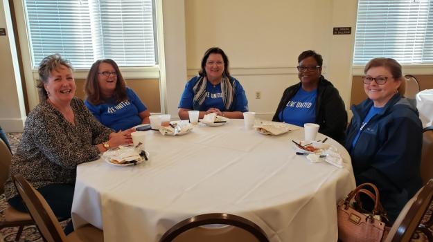 UW Staff and Volunteers Enjoying Conversation over Breakfast