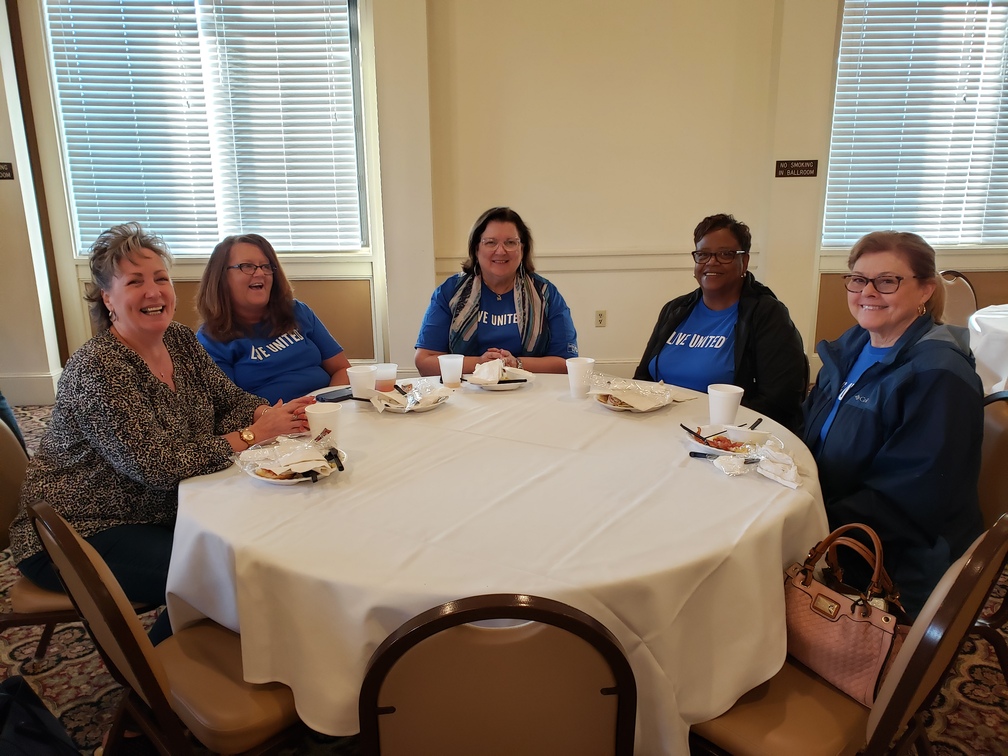 UW Staff and Volunteers Enjoying Conversation over Breakfast