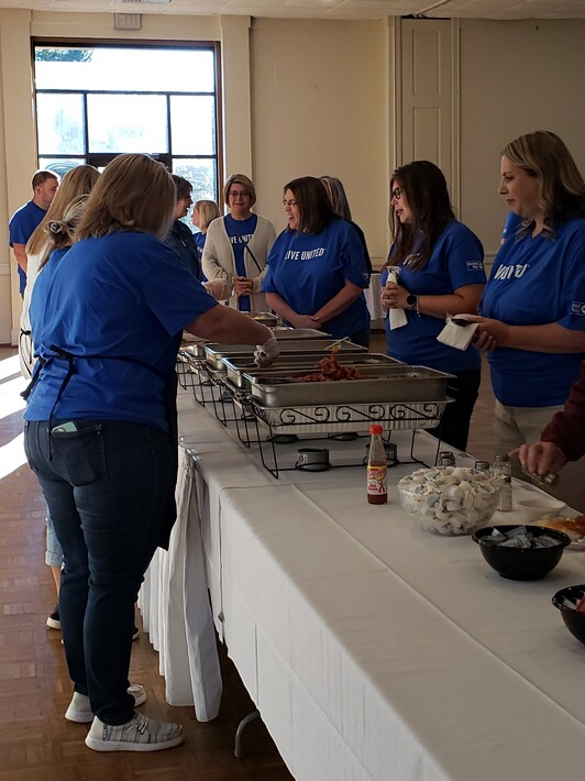 Longwood University Volunteers and UW Staff serving volunteers breakfast